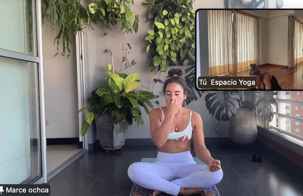 Woman practicing yoga on a patio with plants, virtual class aspect highlighted in inset.